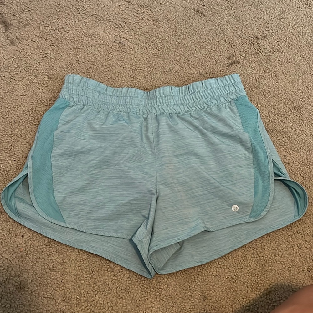 Light teal athletic shorts with back pocket